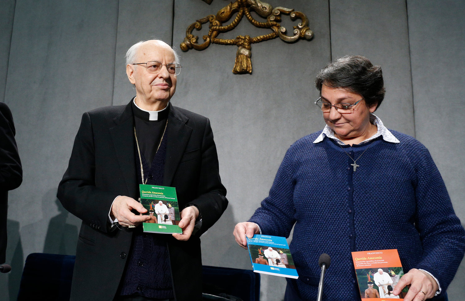 Cardinal Lorenzo Baldisseri, secretary-general of the Synod of Bishops, and Sister Augusta de Oliveira hold copies of Pope Francis’ apostolic exhortation, “Querida Amazonia” (Beloved Amazonia), during its release at a news conference at the Vatican Feb. 12, 2020. The document contains the Pope’s conclusions from the 2019 Synod of Bishops for the Amazon.